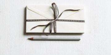 envelop with bow and pencil